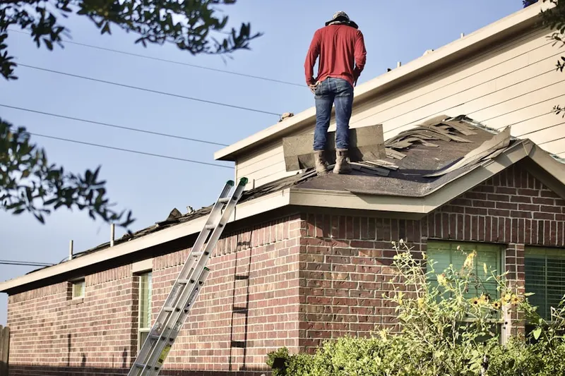 Professional roofer working on a residential roof in Summit Village